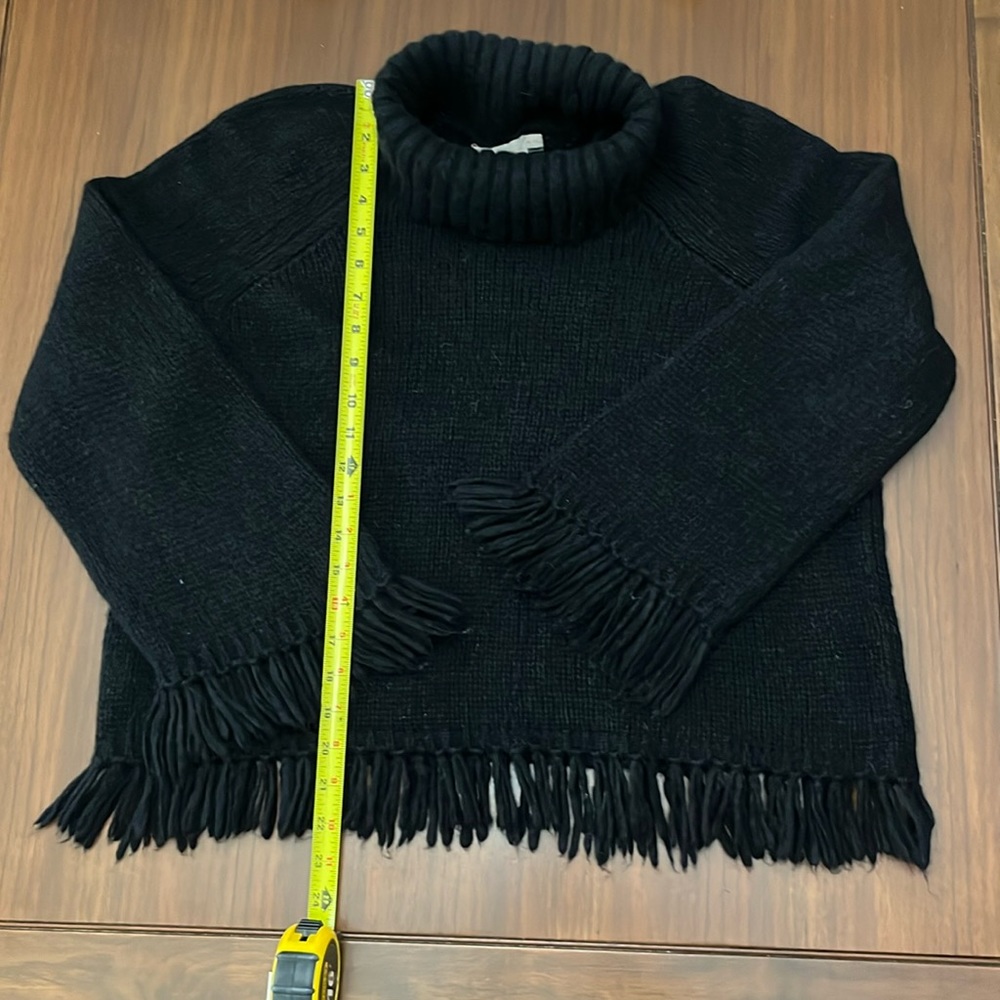 Tory turtleneck adorned with fringe hem and sleeves